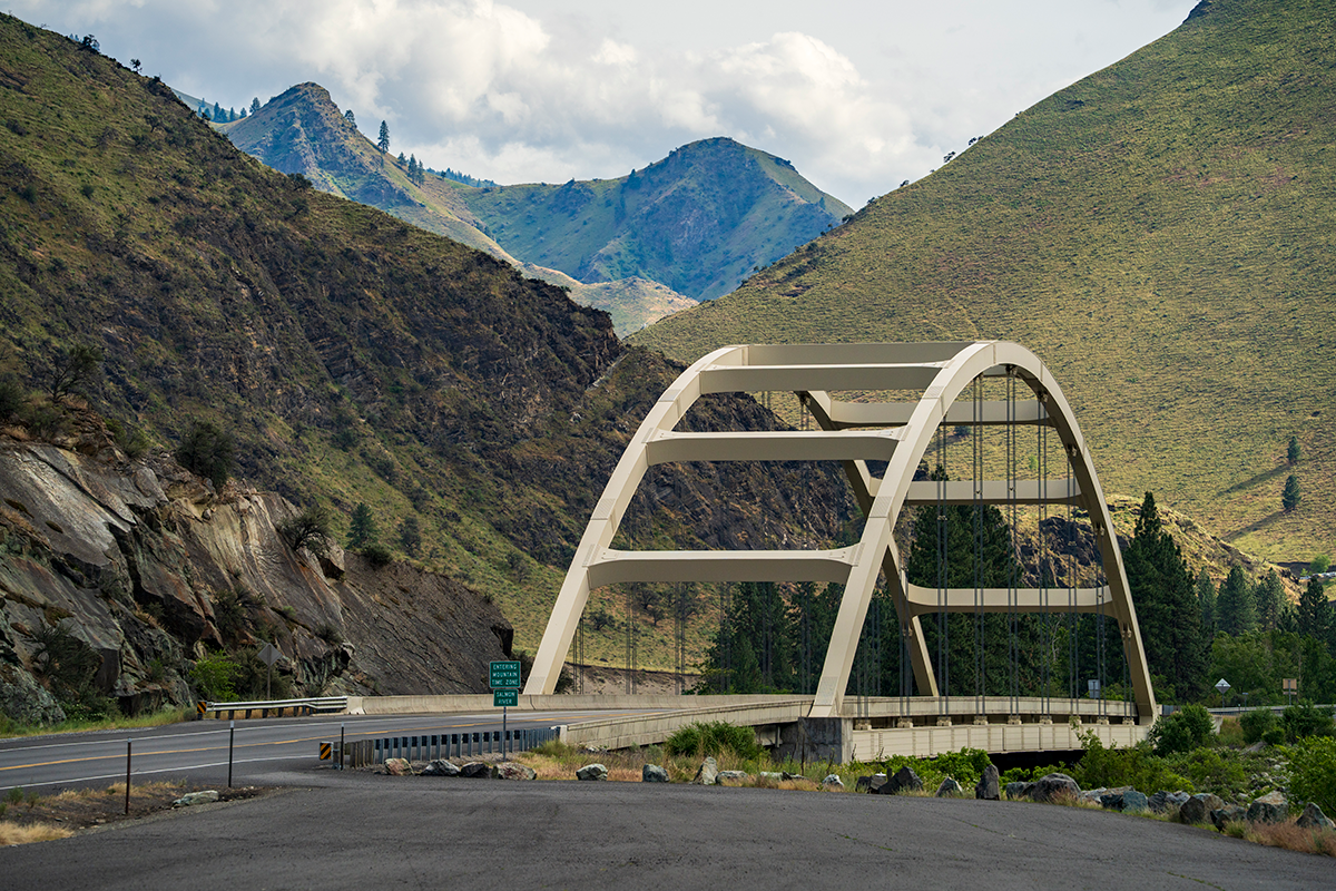 Road bridge surrounded by mountains.