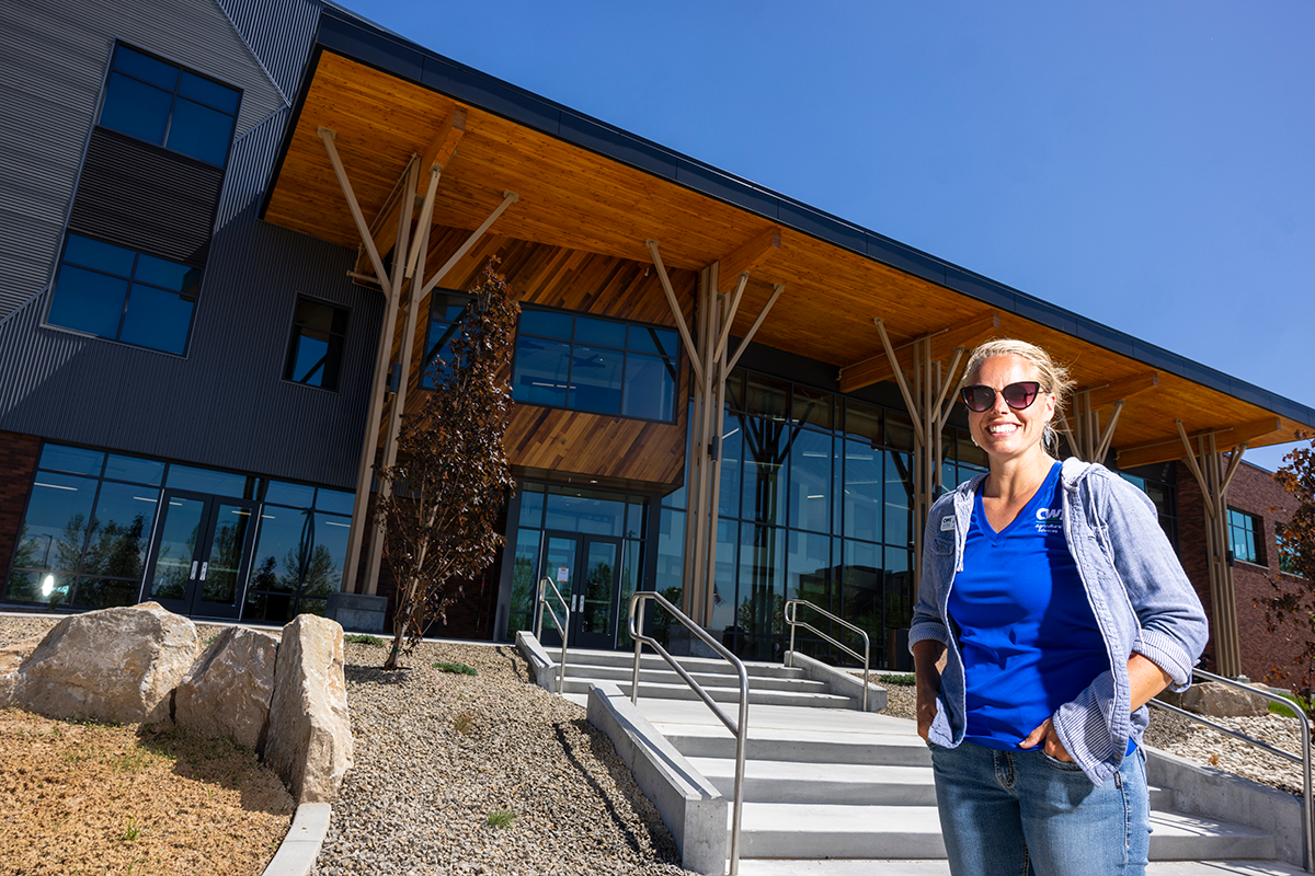 Woman standing in front of college building